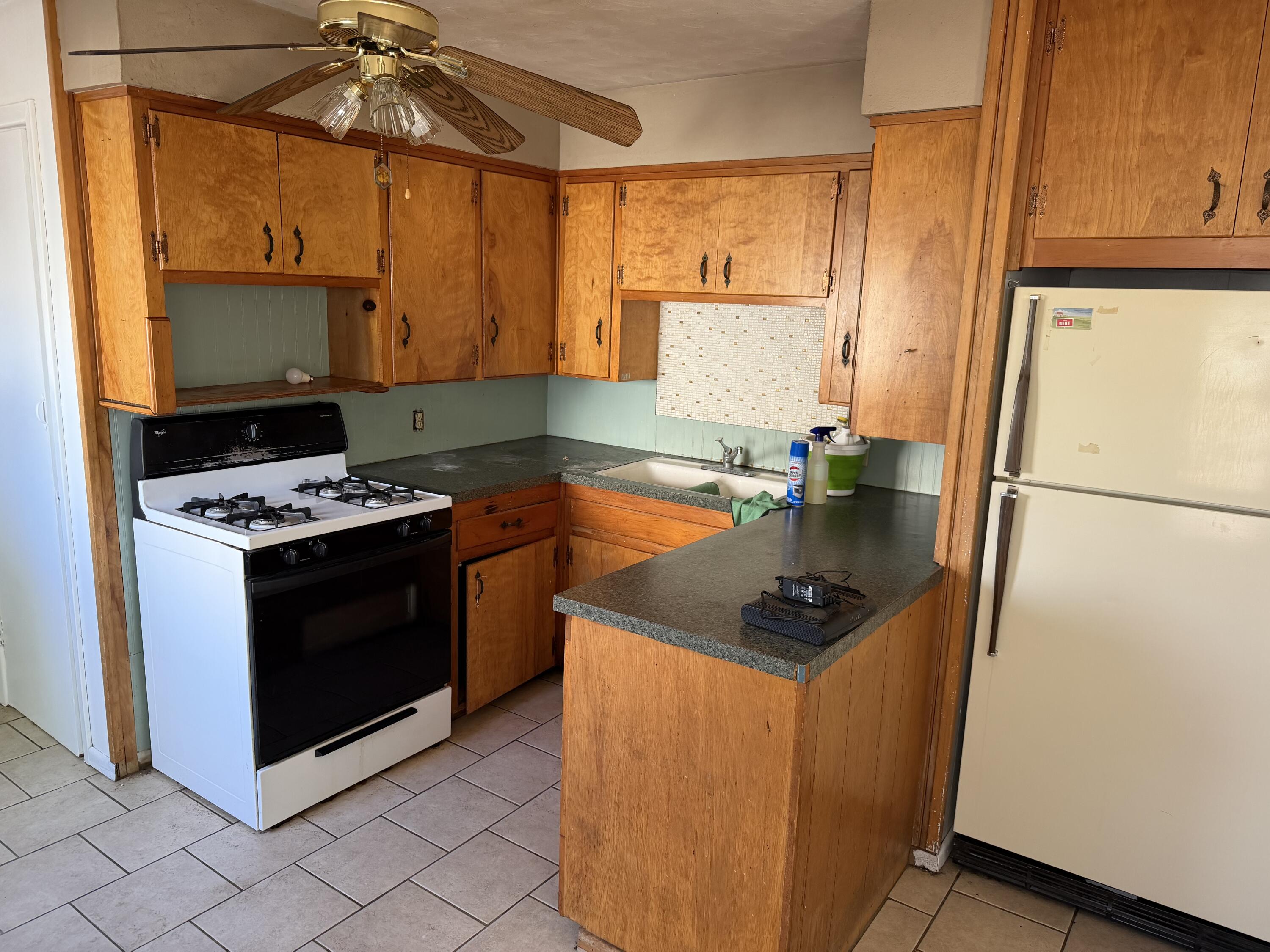 2315 32nd Street Lubbock, TX 79411 - Photo 4 of 9 a kitchen with stainless steel appliances granite countertop a sink stove and refrigerator