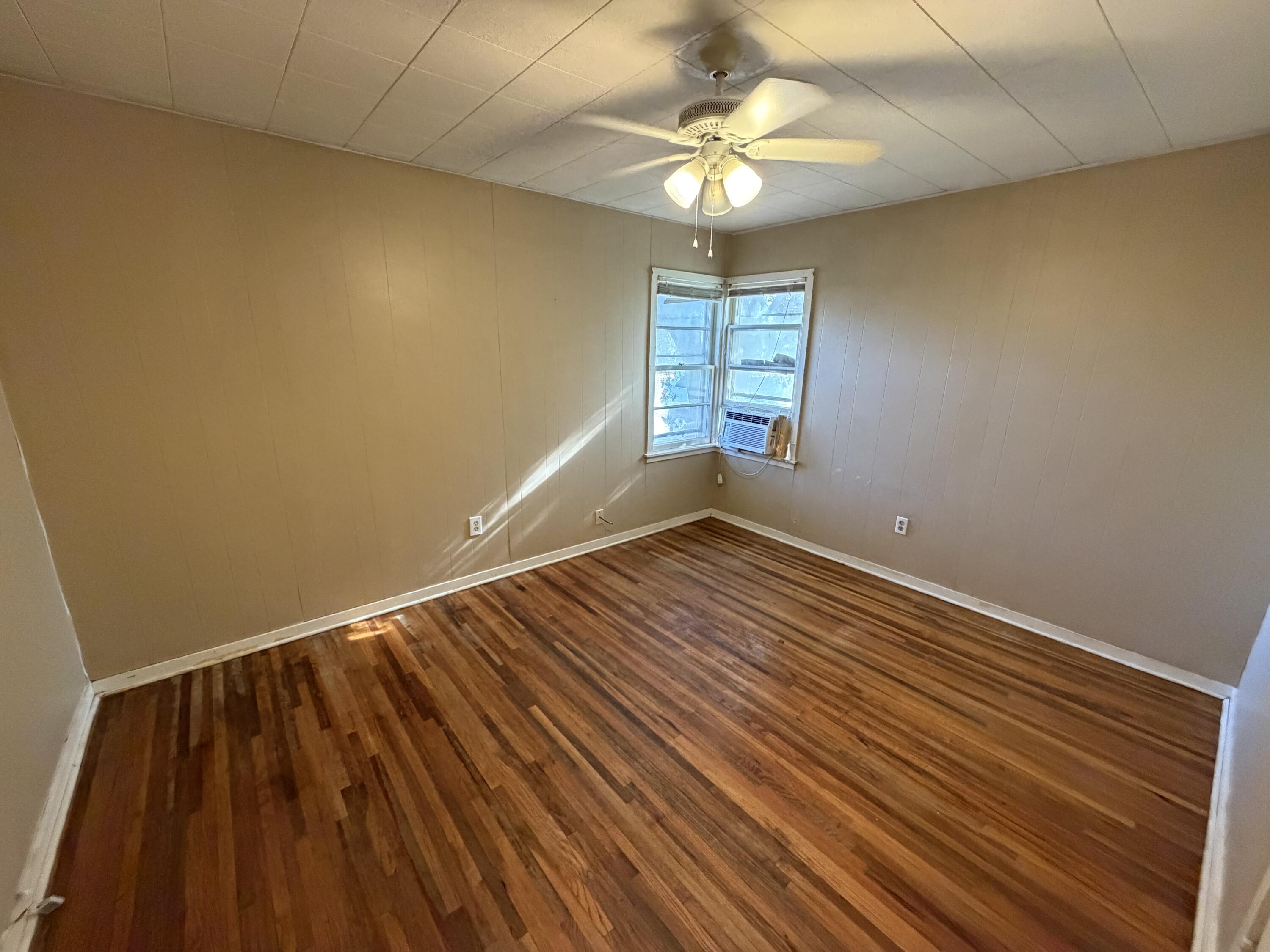 2315 32nd Street Lubbock, TX 79411 - Photo 7 of 9 wooden floor in an empty room with a window