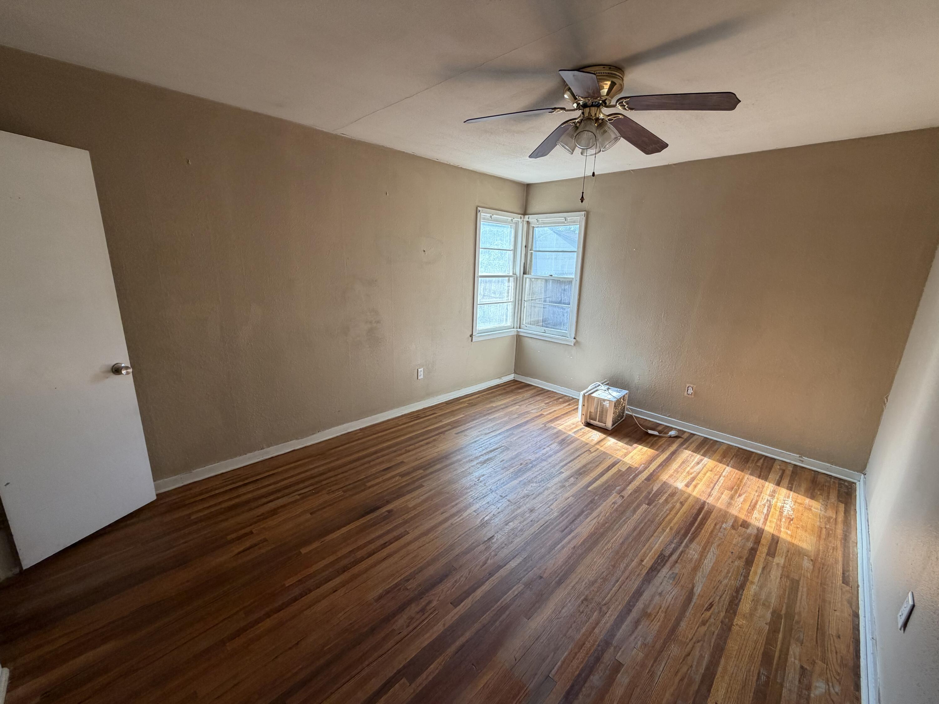 2315 32nd Street Lubbock, TX 79411 - Photo 8 of 9 wooden floor in an empty room with a window