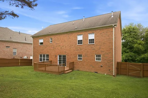 an aerial view of a house with a yard basket ball court and outdoor seating