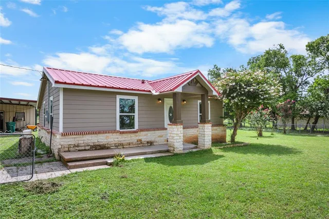a front view of house with yard and green space