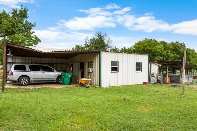 a view of a house with backyard and porch