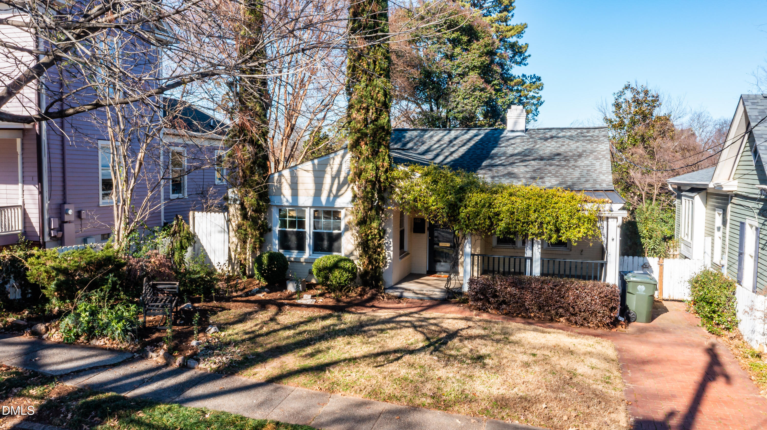 a view of a house with a yard and tree s