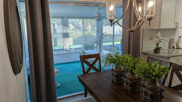 a dining room with furniture and a window