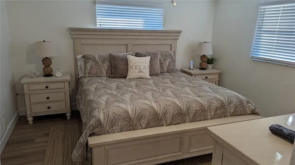 a bedroom with a bed and a mirror