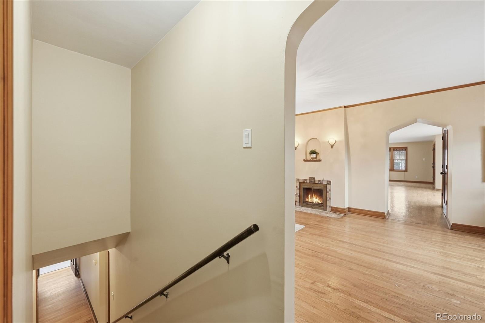 2002 West Ridge Road Littleton, CO 80120 - Photo 14 of 50 a view of a hallway with wooden floor and a living room