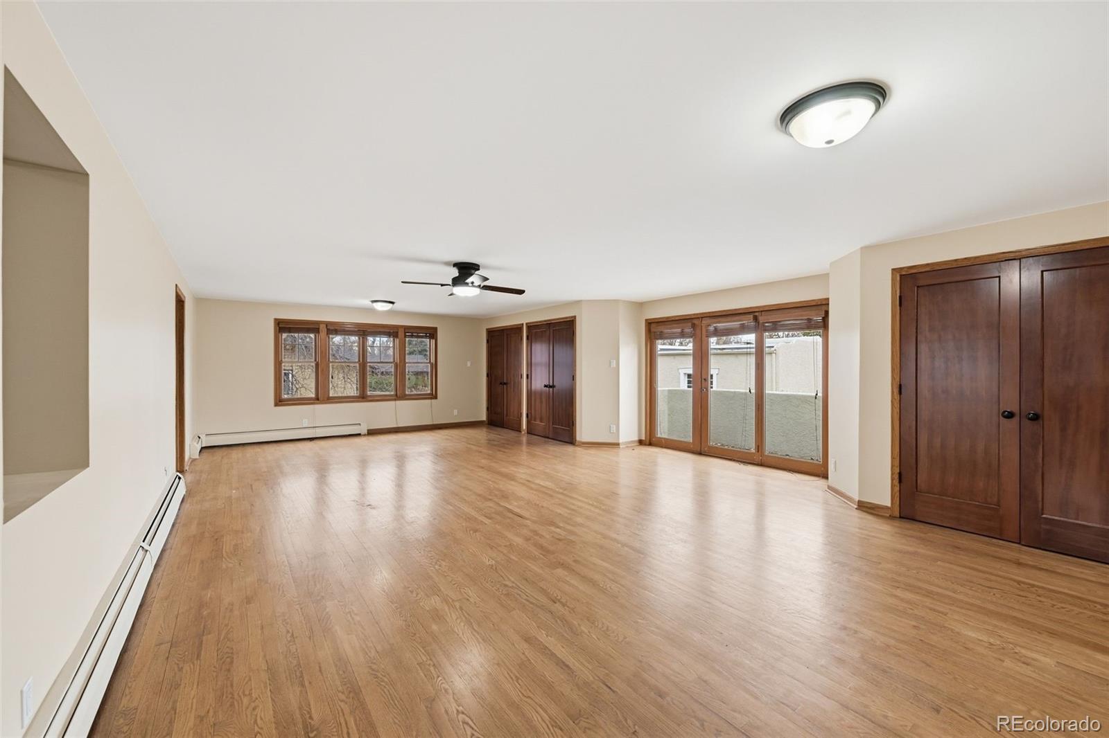 2002 West Ridge Road Littleton, CO 80120 - Photo 15 of 50 a view of an empty room with wooden floor and a window