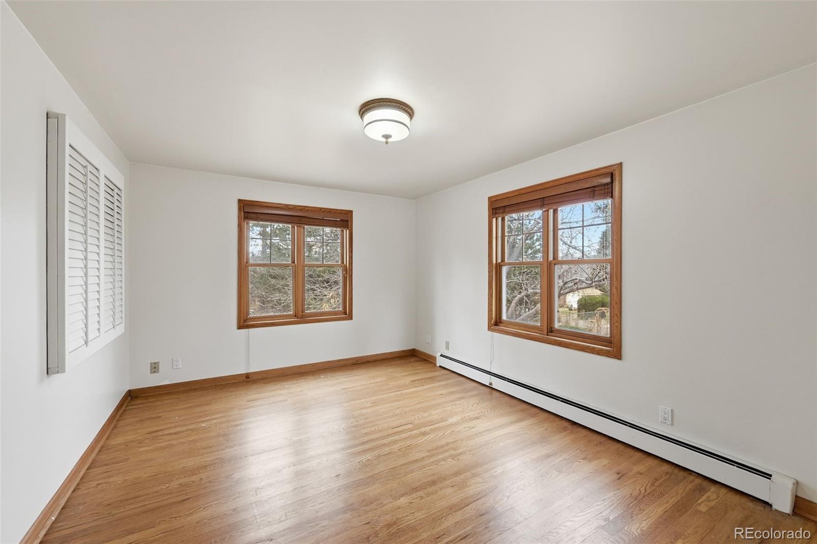2002 West Ridge Road Littleton, CO 80120 - Photo 18 of 50 a view of an empty room with wooden floor and a window