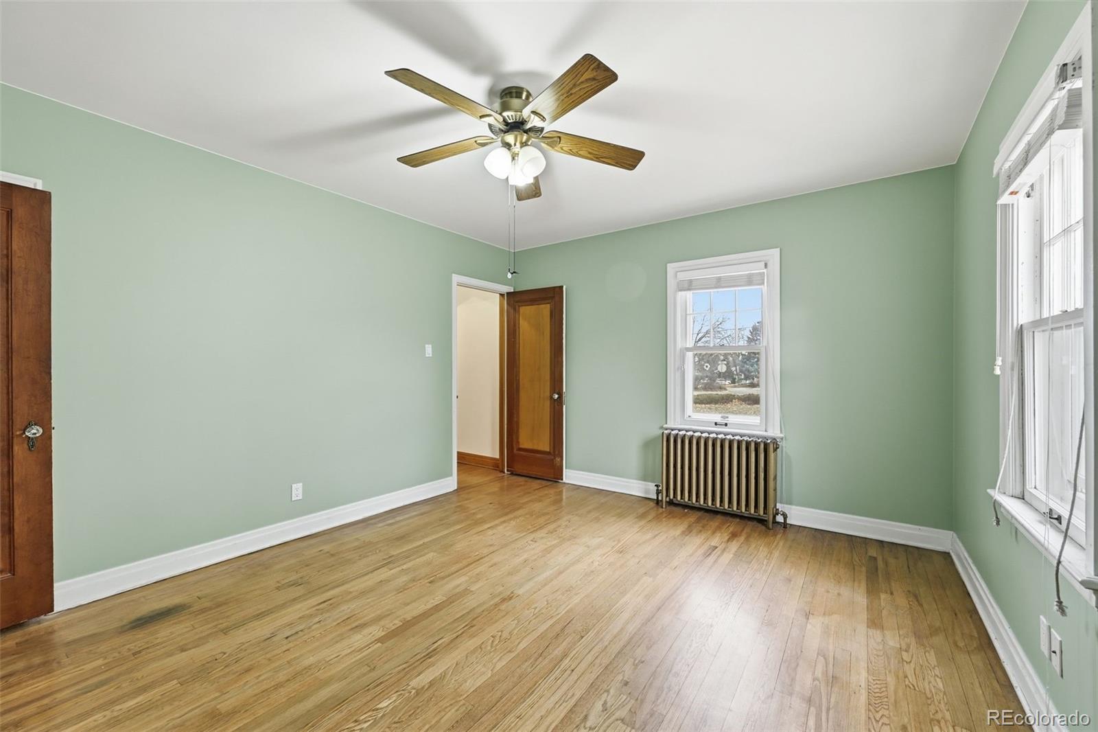 2002 West Ridge Road Littleton, CO 80120 - Photo 19 of 50 a view of an empty room with wooden floor and a window