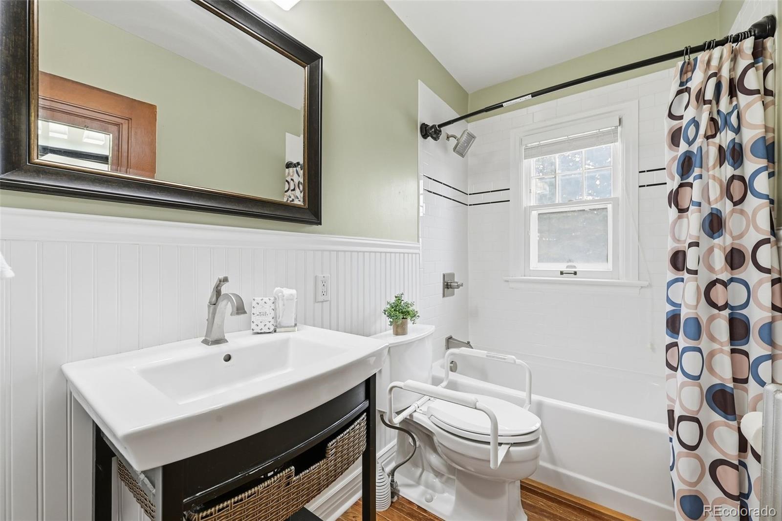 2002 West Ridge Road Littleton, CO 80120 - Photo 20 of 50 a bathroom with a sink toilet a mirror and shower
