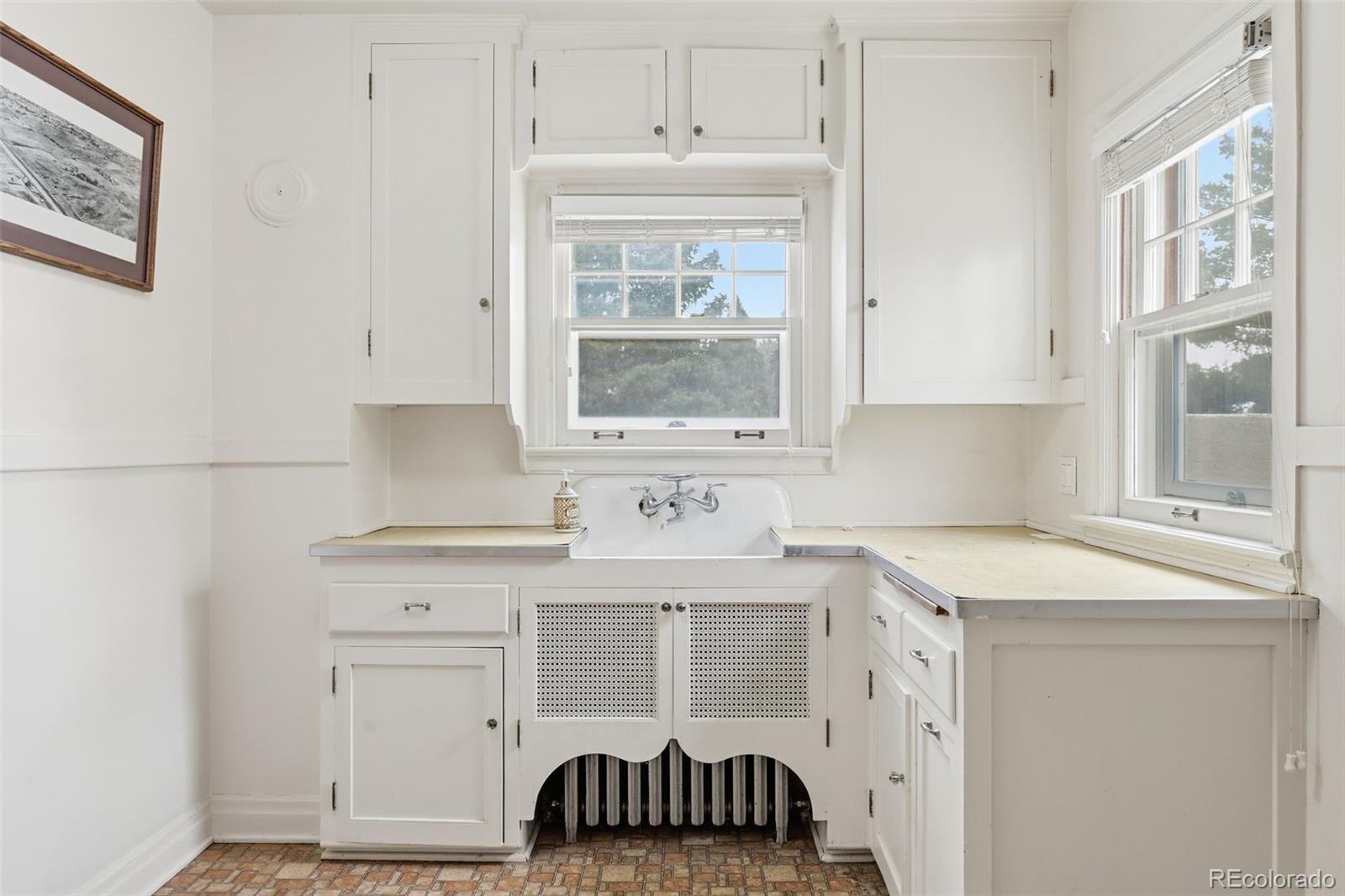 2002 West Ridge Road Littleton, CO 80120 - Photo 21 of 50 a kitchen with a sink cabinets and window