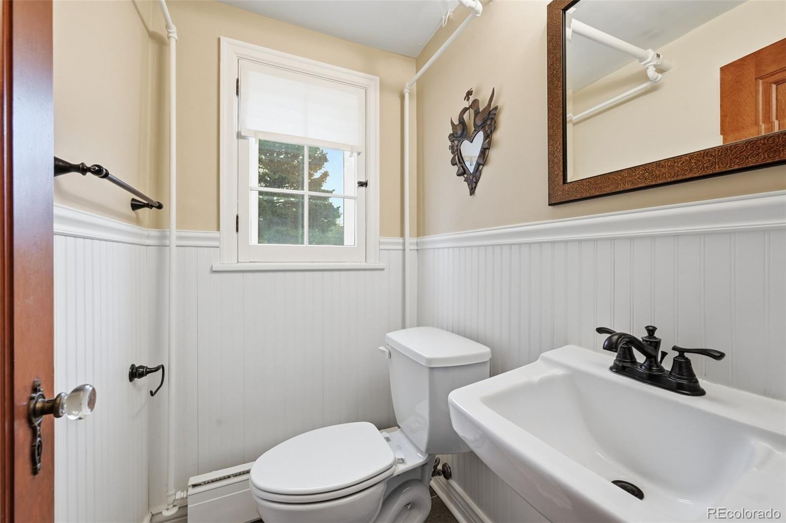 2002 West Ridge Road Littleton, CO 80120 - Photo 28 of 50 a bathroom with a sink mirror and toilet