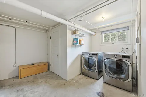 a view of a house with roof deck and furniture