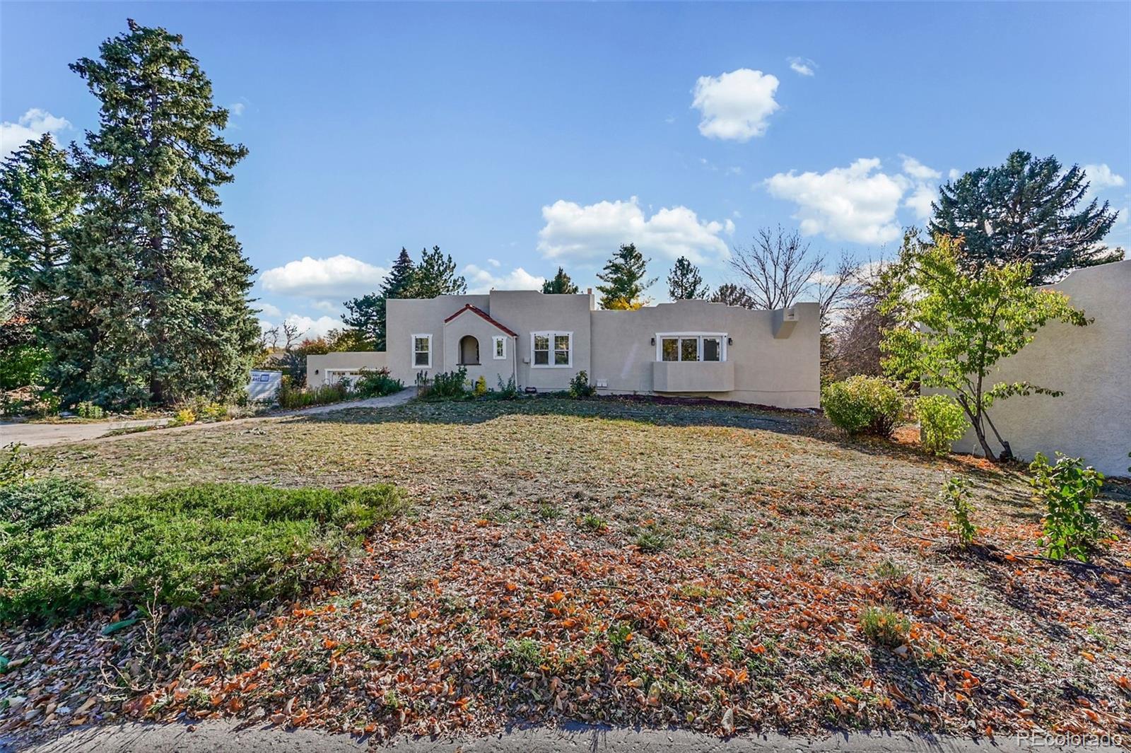 2002 West Ridge Road Littleton, CO 80120 - Photo 35 of 50 a front view of a house with a yard