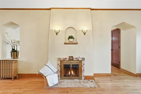 a dining room with furniture wooden floor a potted plant and a chandelier