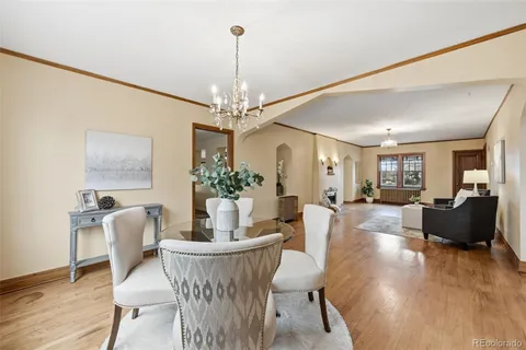 a kitchen with stainless steel appliances granite countertop a stove top oven a sink a dining table and chairs