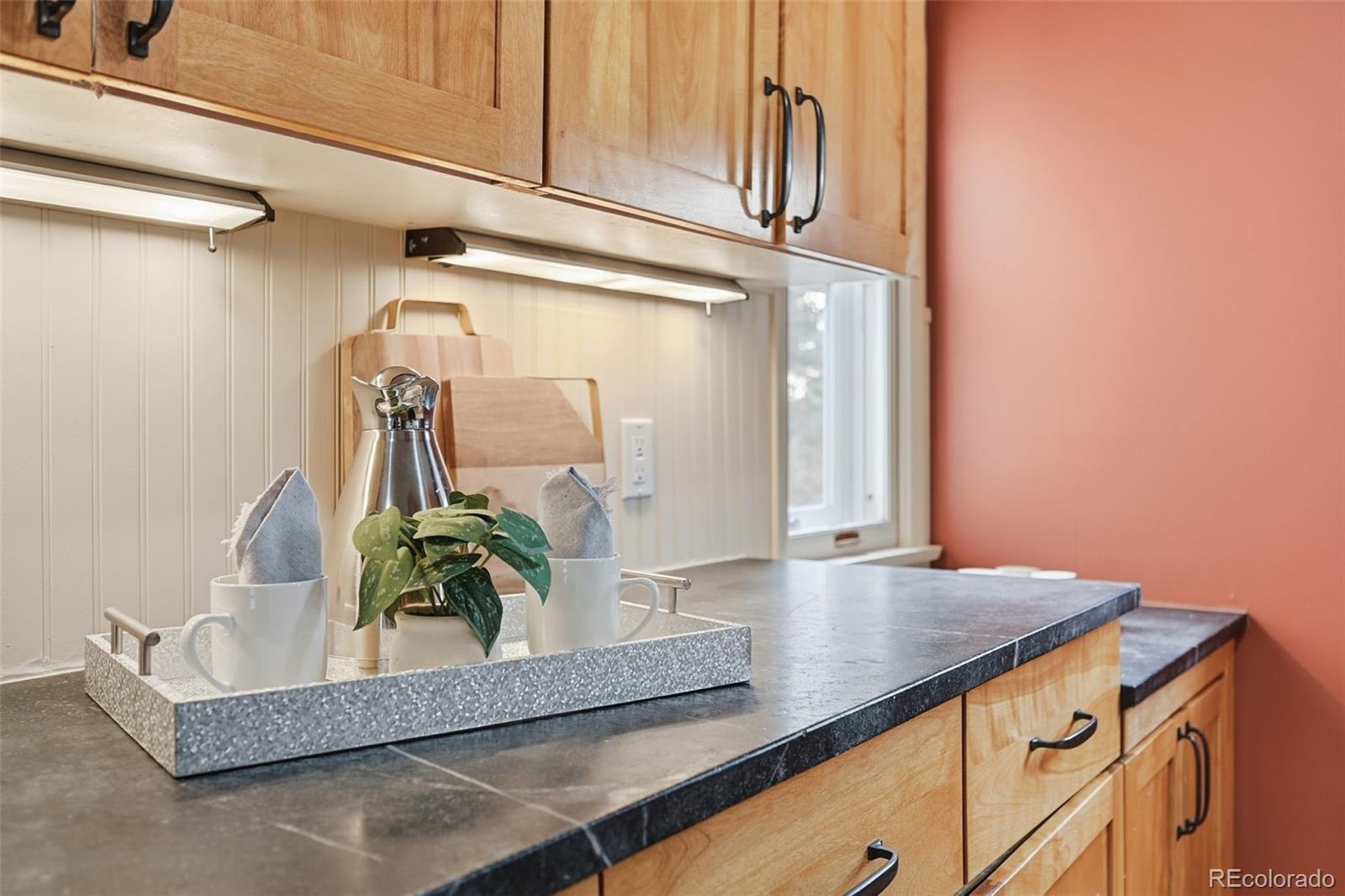 2002 West Ridge Road Littleton, CO 80120 - Photo 10 of 50 a bathroom with a granite countertop sink and a mirror