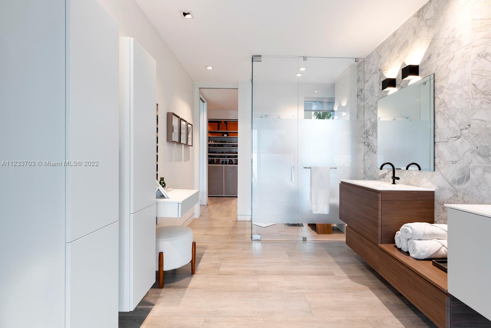 625 Curtiswood Drive Key Biscayne, FL 33149 - Photo 22 of 58 a spacious bathroom with a tub sink and toilet