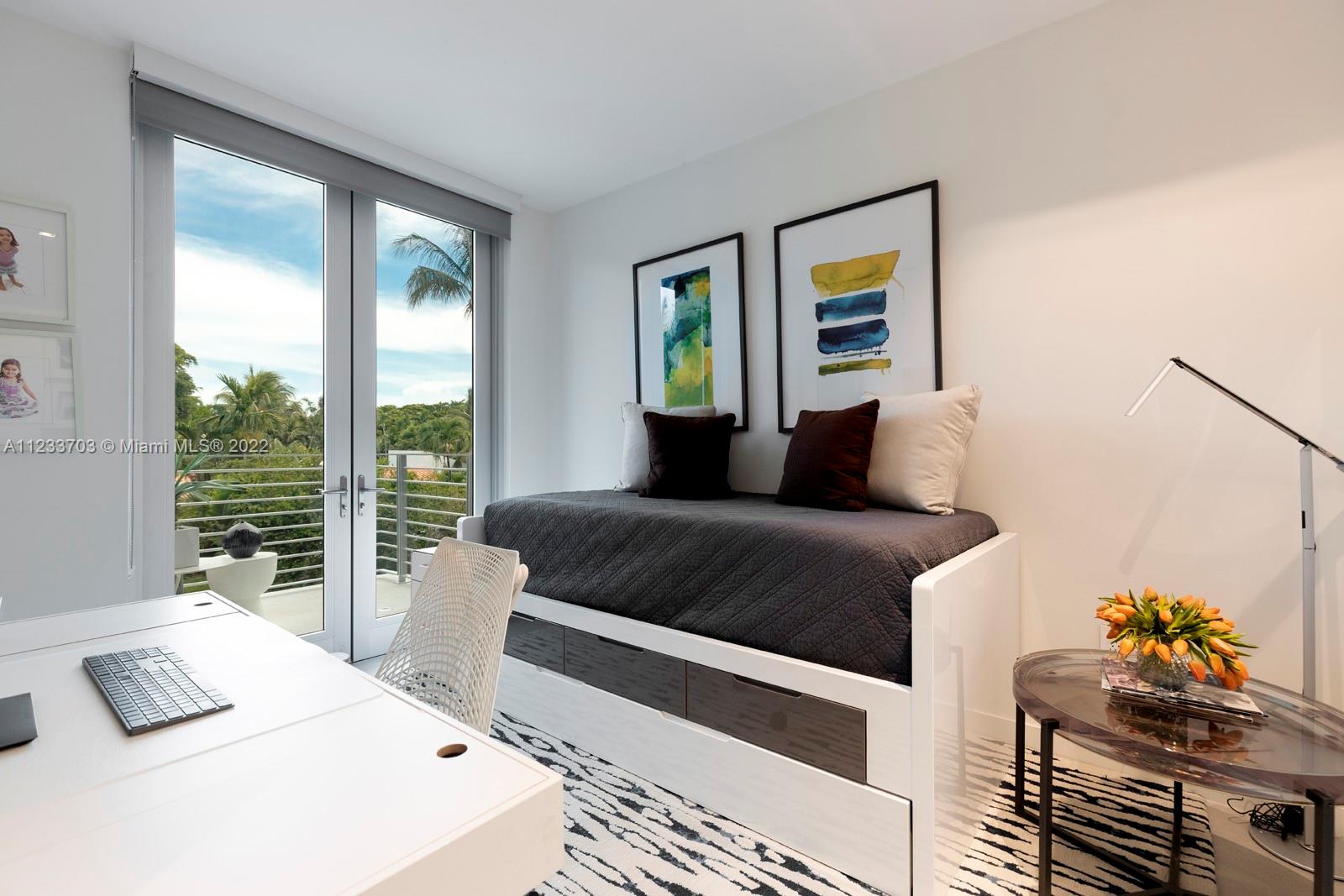 625 Curtiswood Drive Key Biscayne, FL 33149 - Photo 35 of 58 a bedroom with a bed and wooden floor