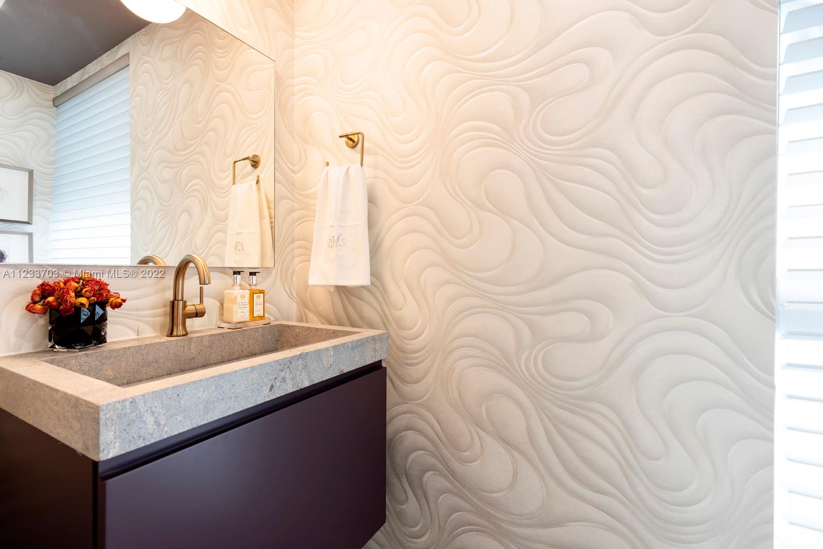 625 Curtiswood Drive Key Biscayne, FL 33149 - Photo 37 of 58 a bathroom with a sink and a mirror