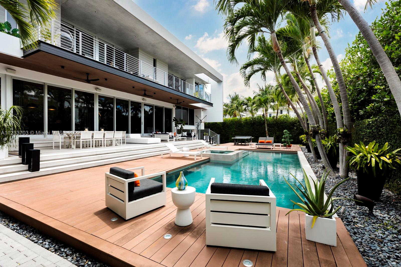 625 Curtiswood Drive Key Biscayne, FL 33149 - Photo 42 of 58 a swimming pool with outdoor seating and yard