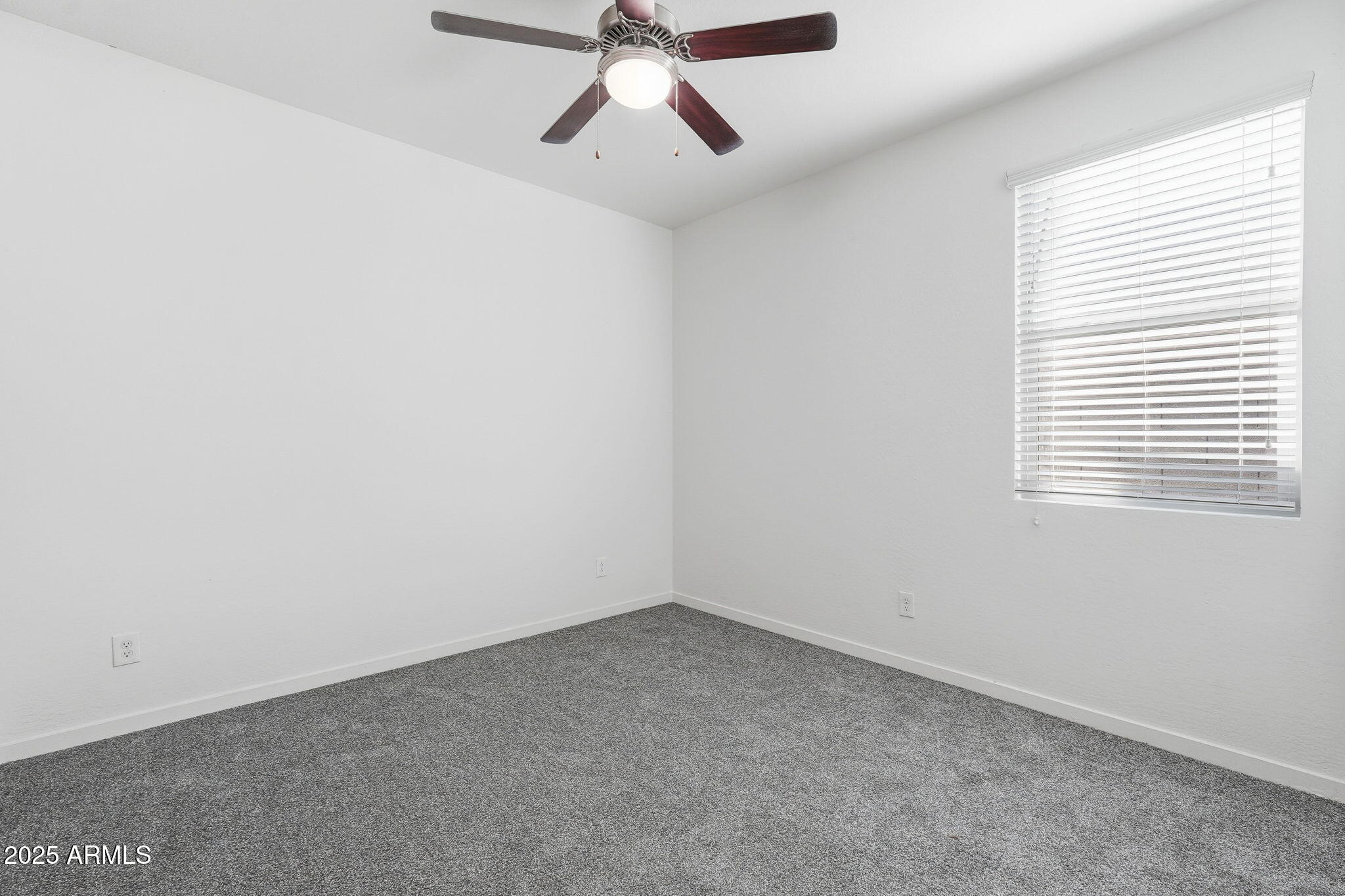 21383 West Granada Road Buckeye, AZ 85396 - Photo 23 of 40 an empty room with a window and a fan