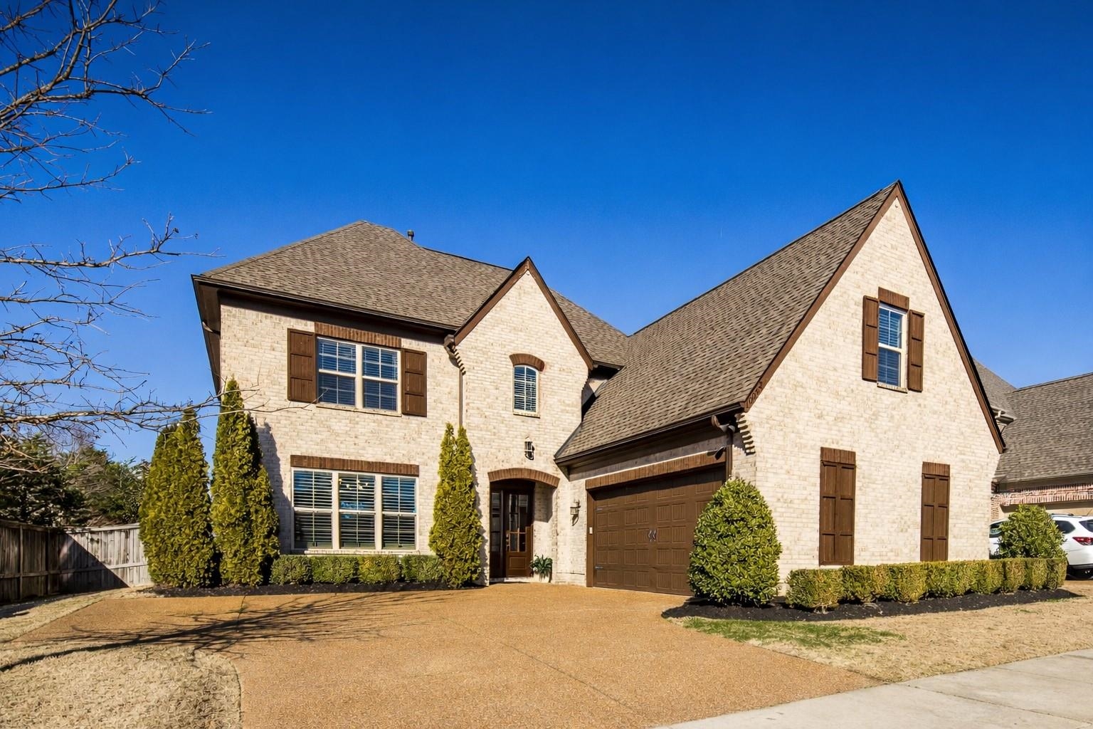 10062 Morning Cross Lane Collierville, TN 38017 - Photo 1 of 39 a front view of a house with a yard