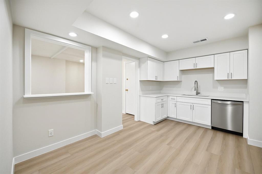 a kitchen with granite countertop white cabinets and white appliances