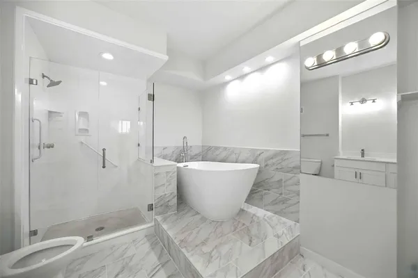a bathroom with a bathtub and shower