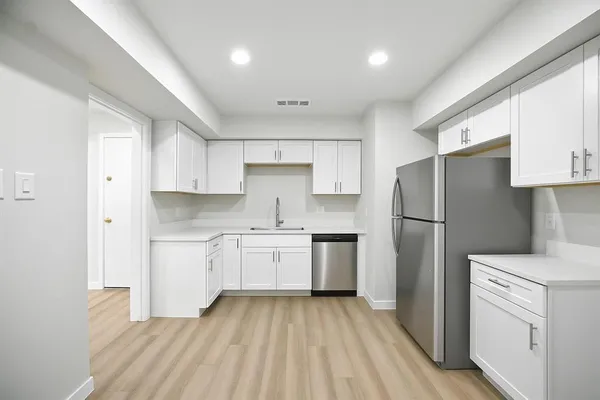 a kitchen with a refrigerator a sink and dishwasher