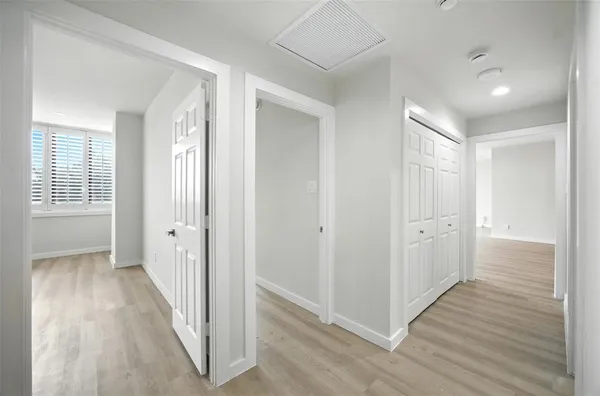 a view of hallway with wooden floor