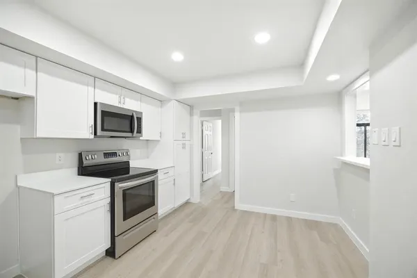 a kitchen with a sink and steel appliances