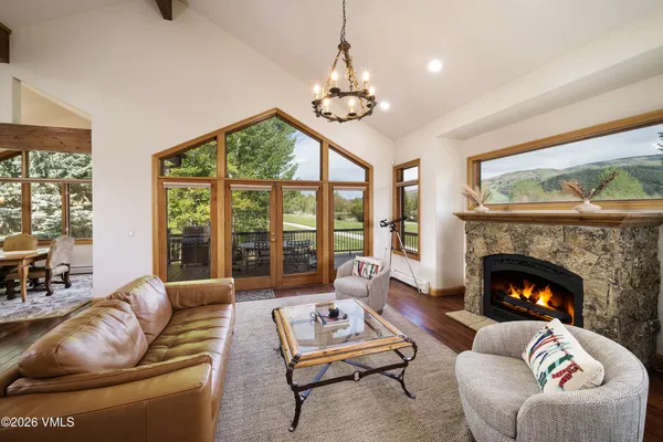 a living room with furniture a fireplace and a large window