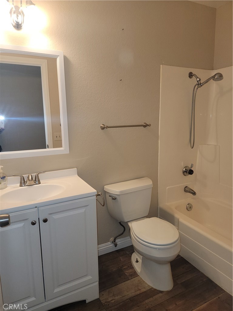 4464 Clarksdale Drive Riverside, CA 92505 - Photo 13 of 23 a white toilet sitting next to a bathroom sink