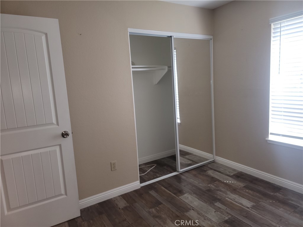 4464 Clarksdale Drive Riverside, CA 92505 - Photo 15 of 23 an empty room with wooden floor and windows