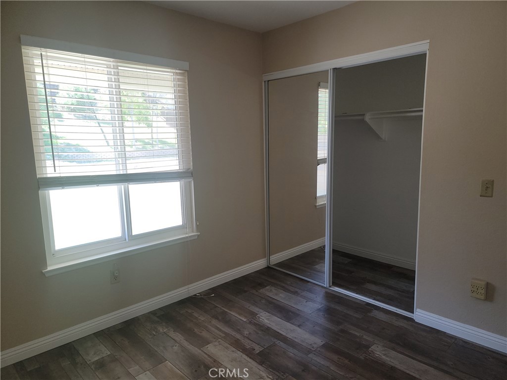 4464 Clarksdale Drive Riverside, CA 92505 - Photo 17 of 23 an empty room with wooden floor and windows