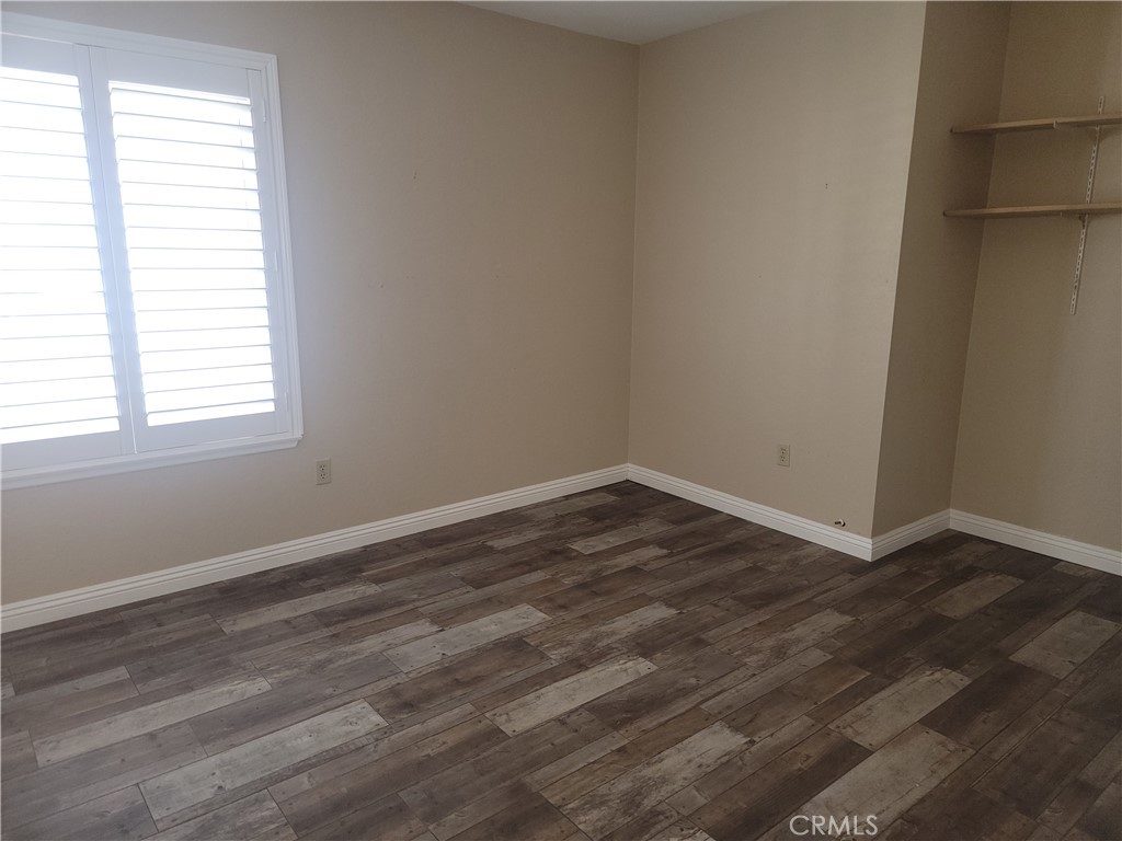 4464 Clarksdale Drive Riverside, CA 92505 - Photo 4 of 23 an empty room with wooden floor and windows
