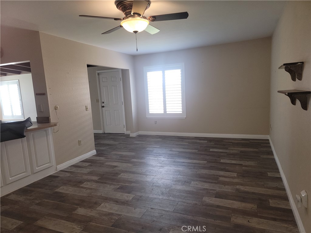 4464 Clarksdale Drive Riverside, CA 92505 - Photo 5 of 23 a view of an empty room with wooden floor and a window