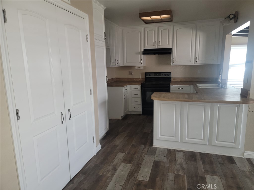 4464 Clarksdale Drive Riverside, CA 92505 - Photo 6 of 23 a kitchen with a refrigerator and a stove top oven