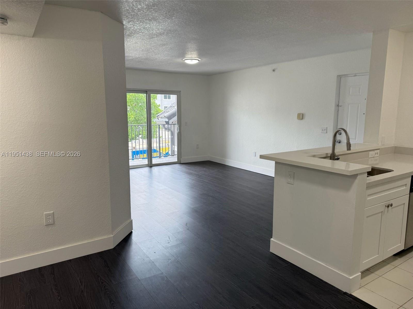 15410 Southwest 284th Street, Unit 8203 Homestead, FL 33033 - Photo 11 of 21 a kitchen with a sink a window and wooden floor
