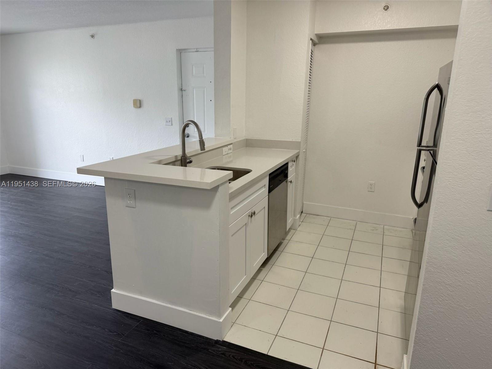 15410 Southwest 284th Street, Unit 8203 Homestead, FL 33033 - Photo 14 of 21 a kitchen with a sink and a mirror
