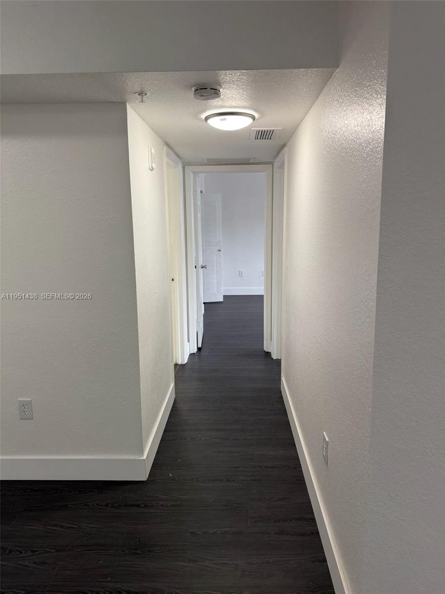 15410 Southwest 284th Street, Unit 8203 Homestead, FL 33033 - Photo 16 of 21 a view of a hallway with wooden floor