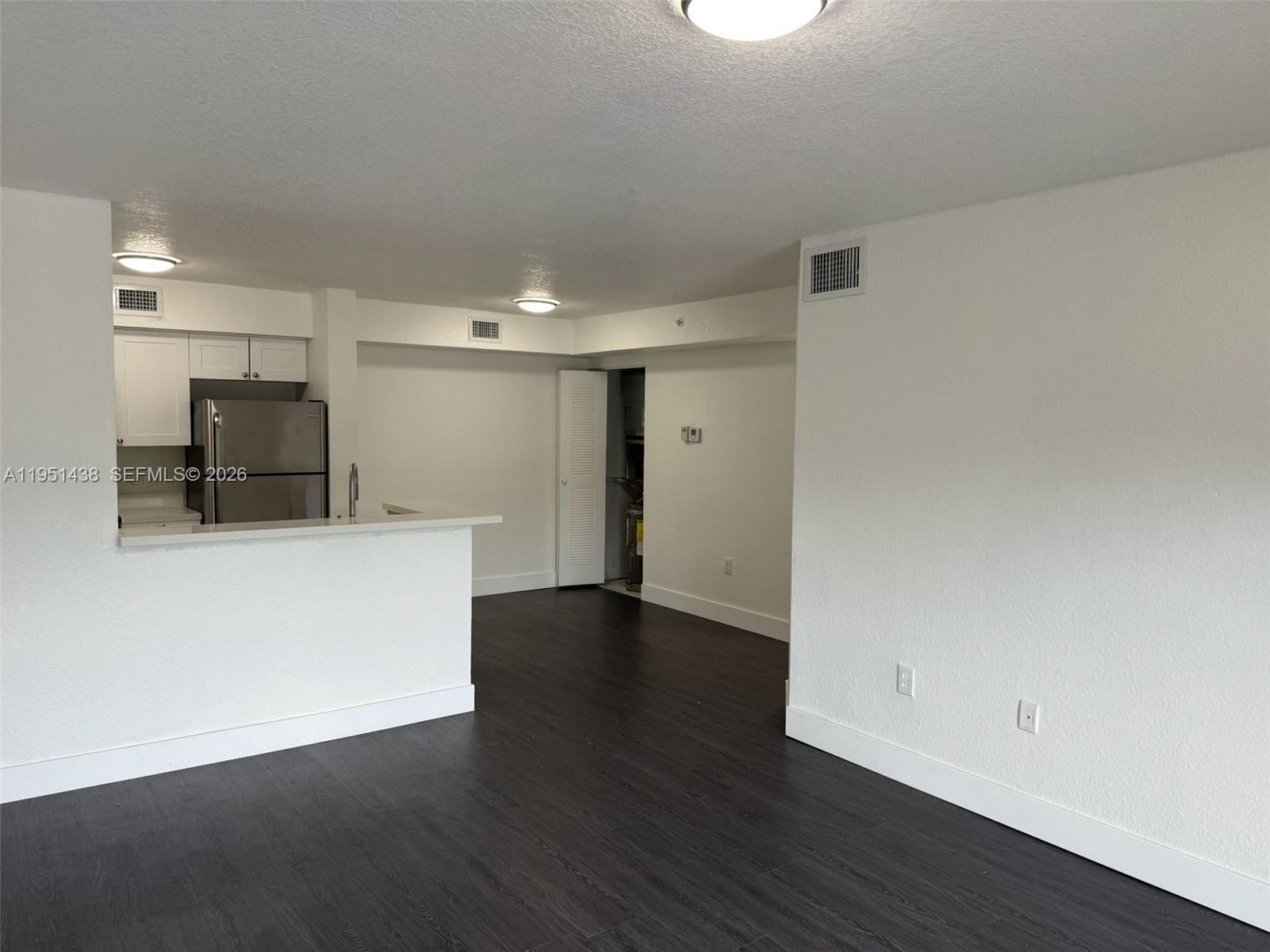 15410 Southwest 284th Street, Unit 8203 Homestead, FL 33033 - Photo 17 of 21 a view of an empty room with wooden floor