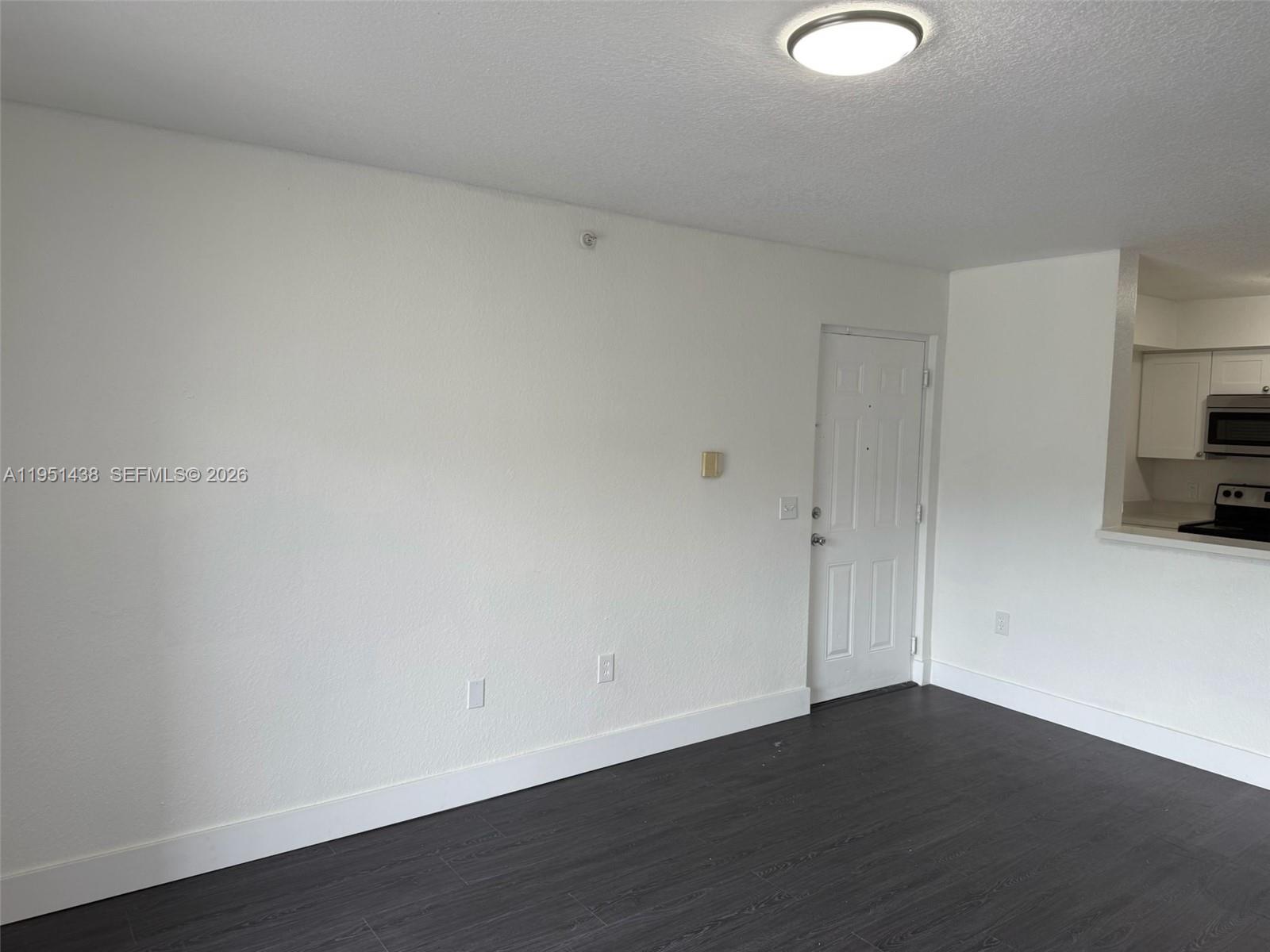 15410 Southwest 284th Street, Unit 8203 Homestead, FL 33033 - Photo 18 of 21 a view of an empty room and wooden floor