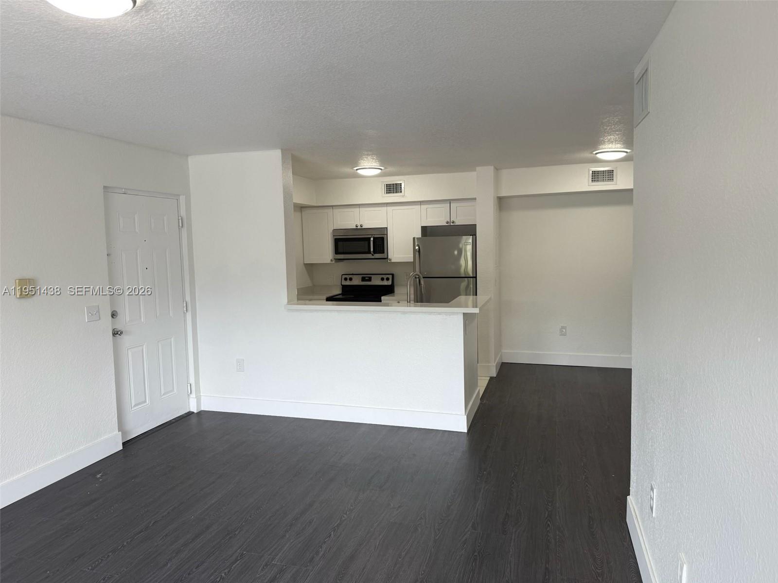 15410 Southwest 284th Street, Unit 8203 Homestead, FL 33033 - Photo 19 of 21 a view of a kitchen with a sink and a refrigerator