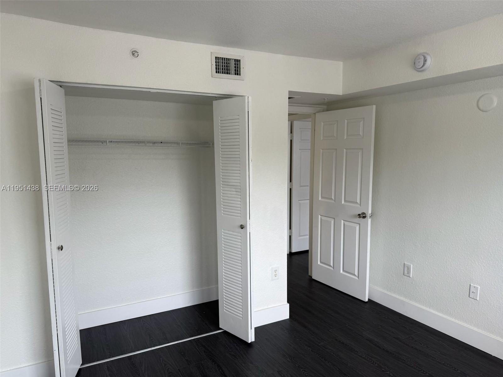 15410 Southwest 284th Street, Unit 8203 Homestead, FL 33033 - Photo 6 of 21 a view of an empty room with wooden floor