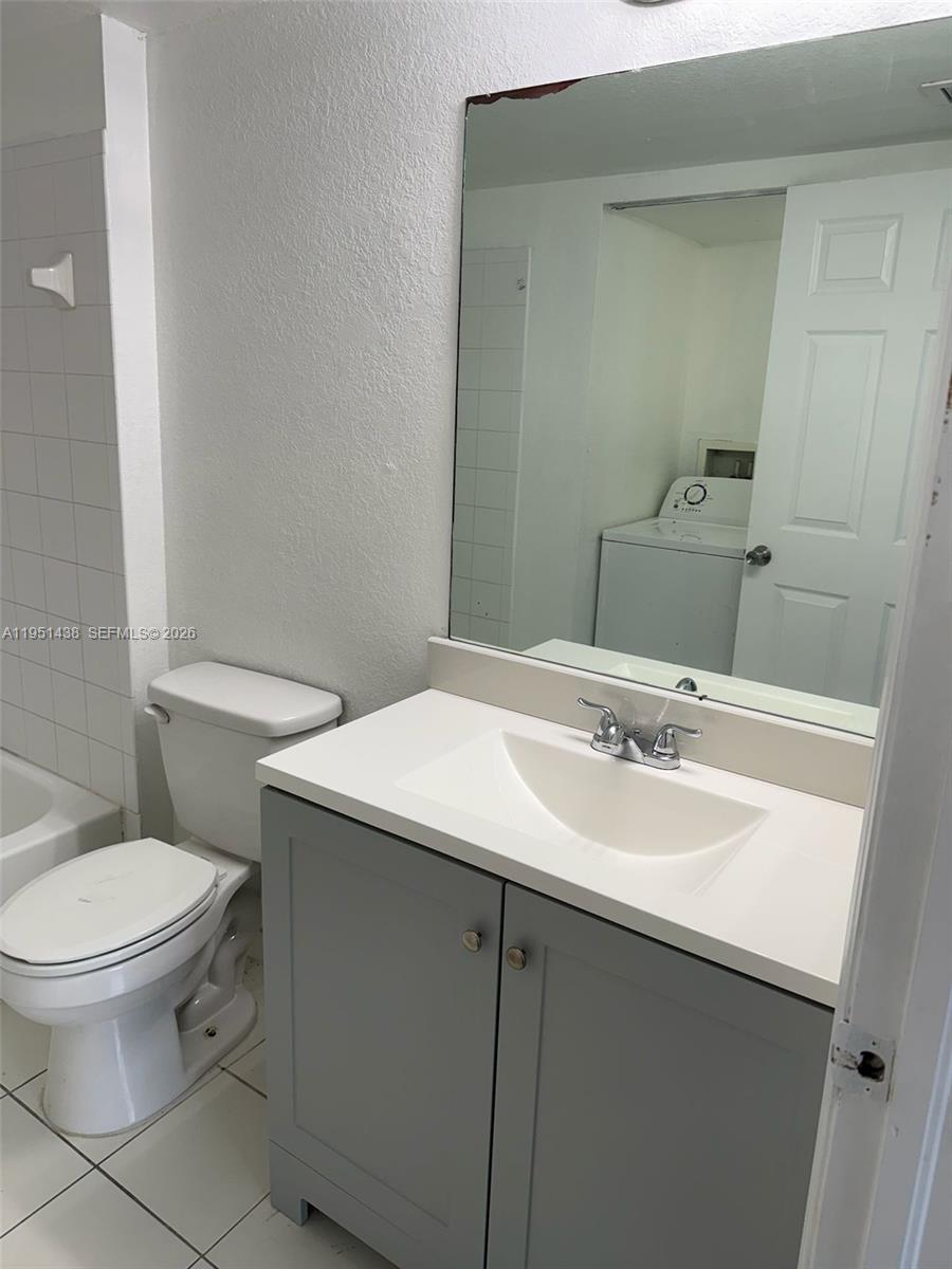 15410 Southwest 284th Street, Unit 8203 Homestead, FL 33033 - Photo 10 of 21 a bathroom with a sink toilet and mirror