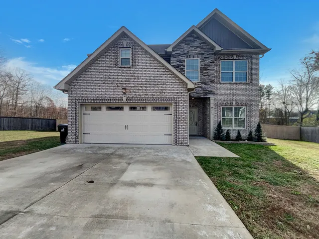 a front view of a house with a yard and garage