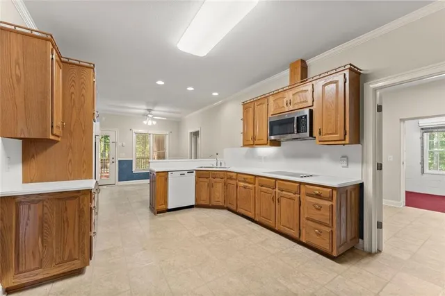 a view of a big room with windows and chandelier fan