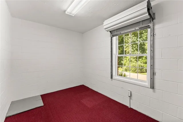 an empty room with a empty space and windows